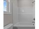 This bathroom features a bathtub with white walls and a window, and a view of the sky at 150 Brookhaven Dr, Spring Hope, NC 27882