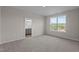 The bedroom offers a view of the ensuite bathroom and a bright window with a view of trees and a blue sky at 150 Brookhaven Dr, Spring Hope, NC 27882