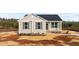 Inviting single-story home with neutral siding, black shutters, and a well-manicured lawn at 150 Brookhaven Dr, Spring Hope, NC 27882