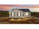 Charming single-story home with a cozy front porch and beautiful sunset sky at 150 Brookhaven Dr, Spring Hope, NC 27882
