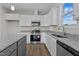 Well-equipped kitchen with stainless steel appliances, granite countertops, and sleek white cabinets at 150 Brookhaven Dr, Spring Hope, NC 27882