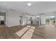 Open-concept living area with hardwood floors, kitchen, and backyard deck access at 150 Brookhaven Dr, Spring Hope, NC 27882