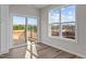 Bright living room with large windows and a sliding glass door to a backyard deck at 150 Brookhaven Dr, Spring Hope, NC 27882