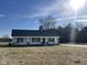 Newly constructed one-story home with a front porch and landscaped yard at 158 Pate Landing Dr, Selma, NC 27576