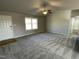 Bright living room with grey carpet and ceiling fan at 158 Pate Landing Dr, Selma, NC 27576