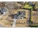 An aerial view of the home in its neighborhood showing mature trees and a long driveway at 1625 Banks View Dr, Raleigh, NC 27603