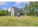 Expansive green backyard featuring patio, outdoor dining, and ample space for various activities and relaxation at 1625 Banks View Dr, Raleigh, NC 27603