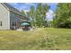 Expansive backyard featuring a patio dining set and a lounge area for outdoor enjoyment and entertaining at 1625 Banks View Dr, Raleigh, NC 27603