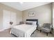 Cozy bedroom with neutral walls, a queen-sized bed, stylish accent chairs, and a world map adding a touch of sophistication at 1625 Banks View Dr, Raleigh, NC 27603