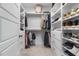 Spacious walk-in closet featuring custom shelving, hanging racks, and neutral carpet at 1625 Banks View Dr, Raleigh, NC 27603