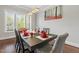Bright dining room with hardwood floors, modern light fixture, and backyard views at 1625 Banks View Dr, Raleigh, NC 27603