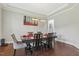 Bright dining room features a long table, modern light fixture, and sleek hardwood flooring at 1625 Banks View Dr, Raleigh, NC 27603