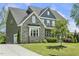 Side view of a beautiful home featuring stone and siding exterior, attached garage, and landscaped grounds at 1625 Banks View Dr, Raleigh, NC 27603