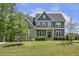 Beautiful home with a stone and siding exterior, a well-manicured lawn, and lush landscaping at 1625 Banks View Dr, Raleigh, NC 27603