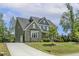 Lovely home with a stone and siding exterior, a long driveway, and a well-manicured lawn at 1625 Banks View Dr, Raleigh, NC 27603