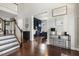 Elegant foyer showcasing hardwood floors, staircase, and a view into an adjacent room perfect for a home office at 1625 Banks View Dr, Raleigh, NC 27603