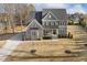Charming home featuring stone accents, a welcoming front porch, and well-manicured landscaping at 1625 Banks View Dr, Raleigh, NC 27603