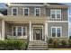 Inviting front porch with stone accents, black railing, a wreath, and a cozy seating area at 1625 Banks View Dr, Raleigh, NC 27603