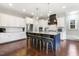 A gorgeous kitchen with a dark island, granite tops, stainless appliances, and convenient barstool seating at 1625 Banks View Dr, Raleigh, NC 27603