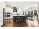 A gourmet kitchen featuring barstool seating, a dark island, granite counters, and dining area at 1625 Banks View Dr, Raleigh, NC 27603