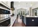 Bright kitchen boasts stainless appliances, granite countertops, and a large island with dark wood floors at 1625 Banks View Dr, Raleigh, NC 27603