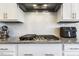 Well-equipped kitchen featuring granite countertops, stainless steel appliances, and a modern gas cooktop at 1625 Banks View Dr, Raleigh, NC 27603