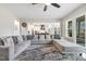 Living room featuring a large sectional sofa, hardwood floors, and a ceiling fan at 1625 Banks View Dr, Raleigh, NC 27603