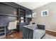 Well-lit home office features custom built-ins and a comfortable sofa, ideal for work or relaxation at 1625 Banks View Dr, Raleigh, NC 27603