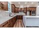 L-shaped kitchen with white island, wood cabinets and stainless steel appliances at 191 Landon Ridge, Sanford, NC 27330