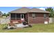 Back exterior view featuring a screened porch, patio and landscaped yard at 2001 Bunnfield Dr, Zebulon, NC 27597