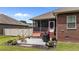 Cozy patio area featuring a grill and bench seating outside a screened porch at 2001 Bunnfield Dr, Zebulon, NC 27597