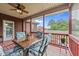 Screened-in back porch with ceiling fan, a table with four chairs and a view of the backyard at 2001 Bunnfield Dr, Zebulon, NC 27597