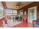 Screened-in back porch with brick walls, ceiling fan and furniture at 2001 Bunnfield Dr, Zebulon, NC 27597