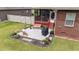 Concrete patio area with seating and grill beside screened in back porch at 2001 Bunnfield Dr, Zebulon, NC 27597