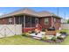 Backyard patio with screened porch, lush landscaping, and outdoor seating creates an inviting retreat at 2001 Bunnfield Dr, Zebulon, NC 27597