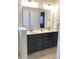 Double vanity bathroom with a large mirror and tile floors at 2001 Bunnfield Dr, Zebulon, NC 27597