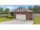 View of the brick home showing the attached garage and well maintained lawn at 2001 Bunnfield Dr, Zebulon, NC 27597