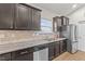 Well-lit kitchen featuring granite countertops, stainless steel appliances and wooden cabinetry at 2001 Bunnfield Dr, Zebulon, NC 27597
