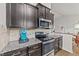 Kitchen with stainless steel appliances, granite countertops and light brick backsplash at 2001 Bunnfield Dr, Zebulon, NC 27597