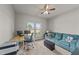 Bright living space with a couch, desk, and window overlooking the outdoors at 2001 Bunnfield Dr, Zebulon, NC 27597