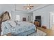 Comfortable main bedroom featuring a ceiling fan, television and natural light at 2001 Bunnfield Dr, Zebulon, NC 27597