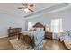 Spacious main bedroom featuring a tray ceiling, ceiling fan and hardwood flooring at 2001 Bunnfield Dr, Zebulon, NC 27597
