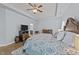 Relaxing main bedroom with wood floors, ceiling fan, television and decorative rug at 2001 Bunnfield Dr, Zebulon, NC 27597
