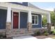 Red front door, stone columns, and a welcoming porch at 211 W Harnett St, Dunn, NC 28334