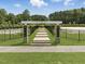 The 'Bark Park' entrance to the community's dog park features a grassy play area and pet waste station at 227 Augusta Pond Way # 159, Raleigh, NC 27603