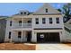 New construction, two-story home boasts a welcoming front porch and attached two-car garage at 227 Augusta Pond Way # 159, Raleigh, NC 27603