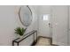 Bright entryway with a round mirror, console table, and rug at 2328 Sugar Cone Way, Fuquay Varina, NC 27526