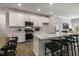 Open concept kitchen with white cabinets, island, and stainless steel appliances at 2328 Sugar Cone Way, Fuquay Varina, NC 27526