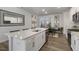 Open kitchen with white cabinets, large island, and stainless steel appliances at 2334 Sugar Cone Way, Fuquay Varina, NC 27526