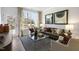 Living room with large windows, comfortable seating, and wood floors at 2334 Sugar Cone Way, Fuquay Varina, NC 27526